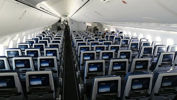 Cabine de avião em classe econômica com fileiras de poltronas